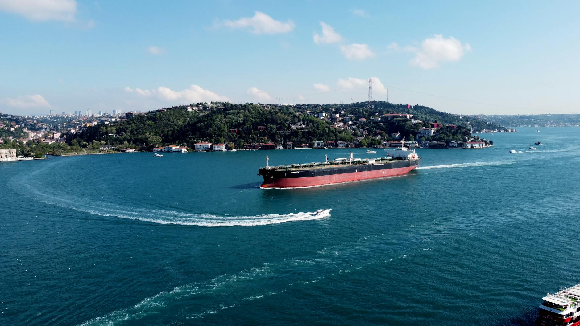 Aerial view of a cargo ship navigating through the Bosphorus Strait in Istanbul, Turkey.