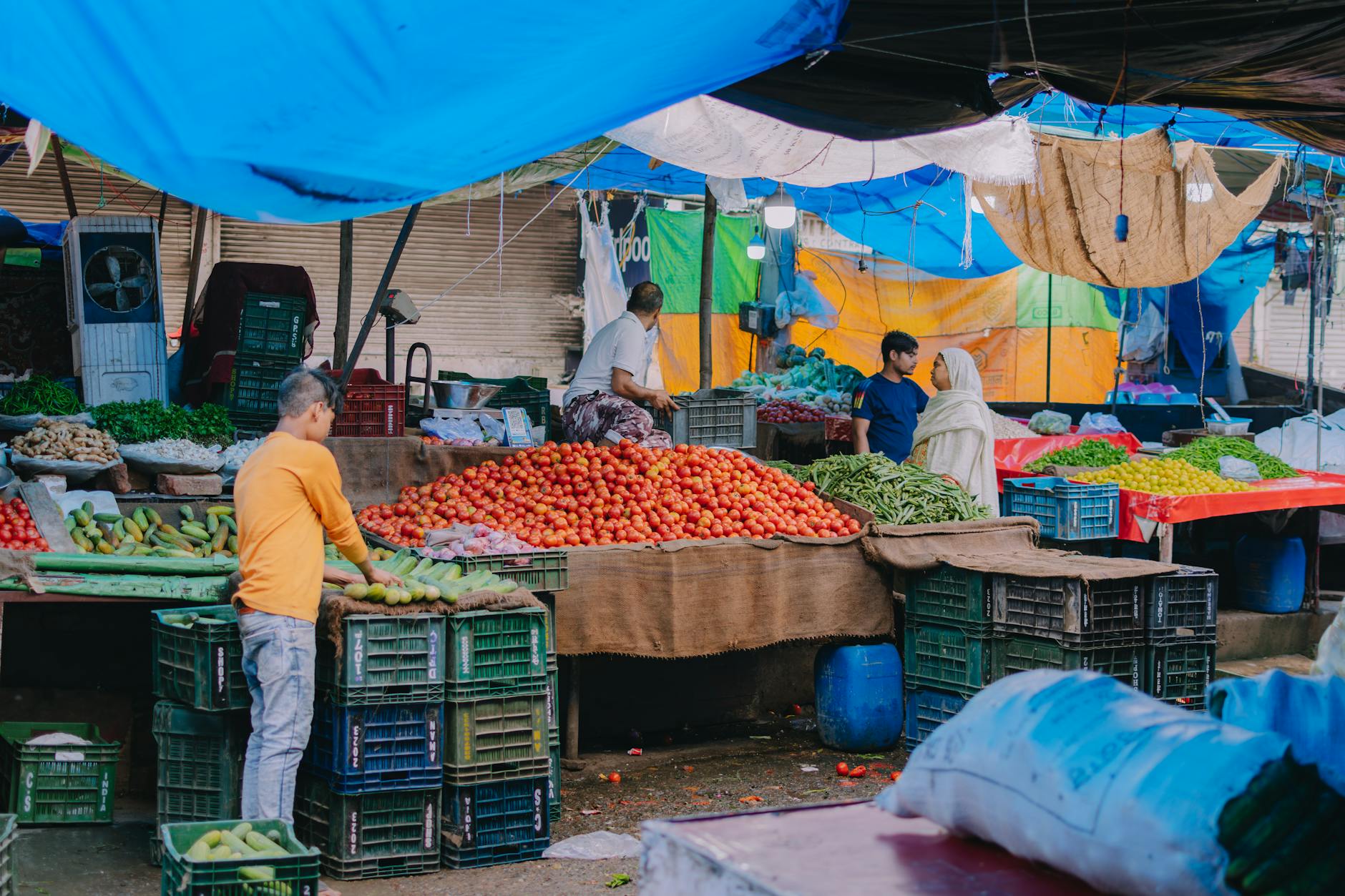 A lively outdoor market scene showcasing vendors selling fresh fruits and vegetables.