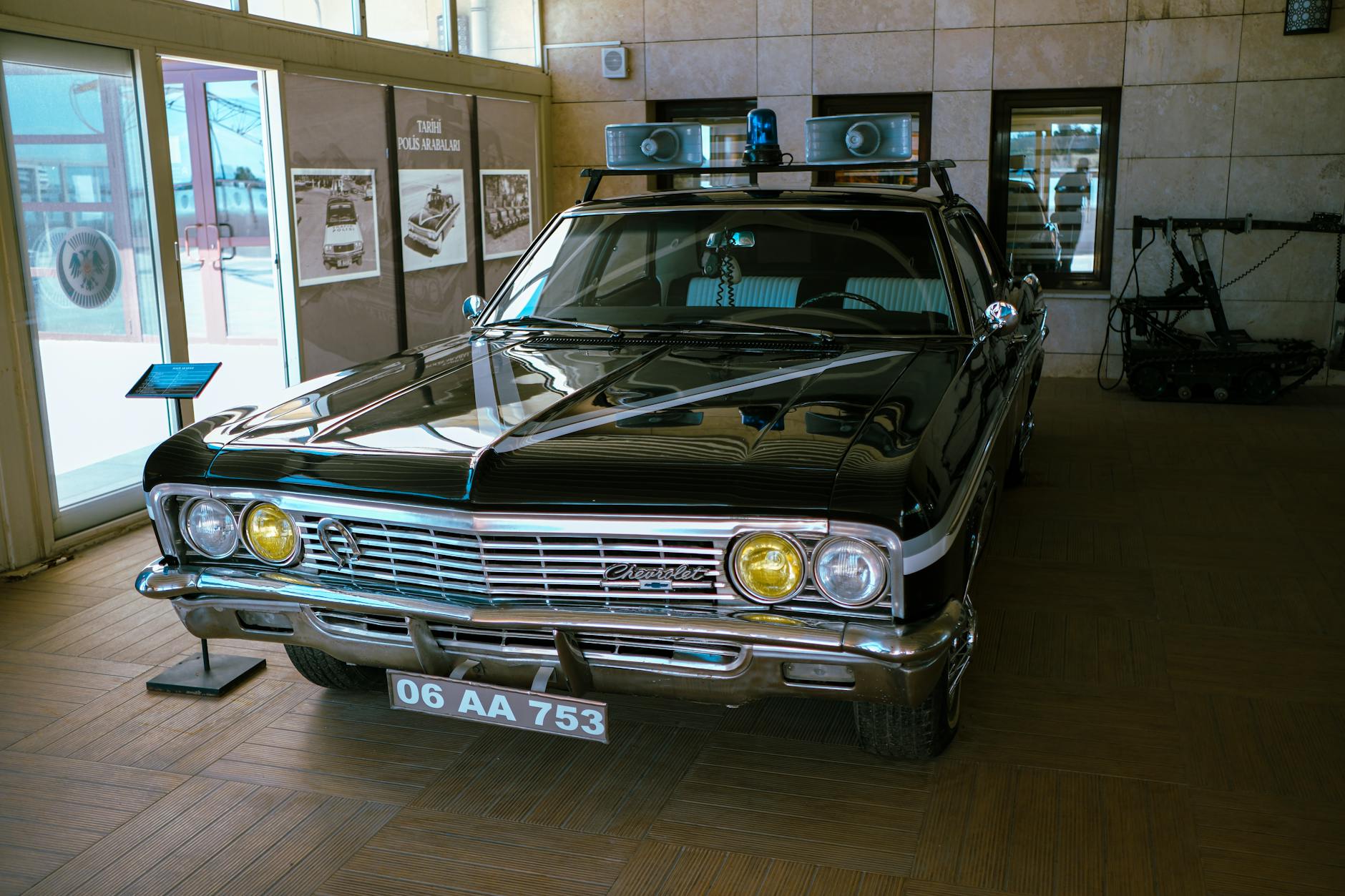 Classic police car exhibited at Ankara museum with historical displays.